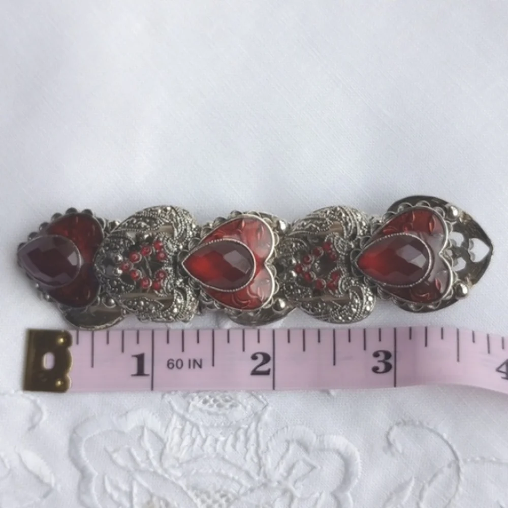 Red enamel and rhinestone encrusted silvertone heart-shaped stretchy bracelet